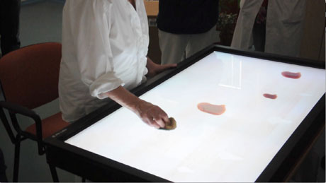 Training phase: an elderly patient using the interactive tabletop at Montedomini.