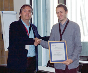 Georg Fuchsbauer (right) receives the ERCIM Security and Trust Management PhD thesis award from Javier Lopez. 