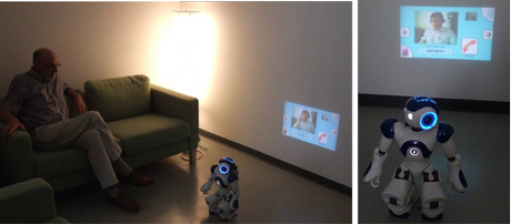 Figure 2: NAO robot with a LED projector unit on its back during video communication between KSERA user (sitting on a couch) and a call centre operator.