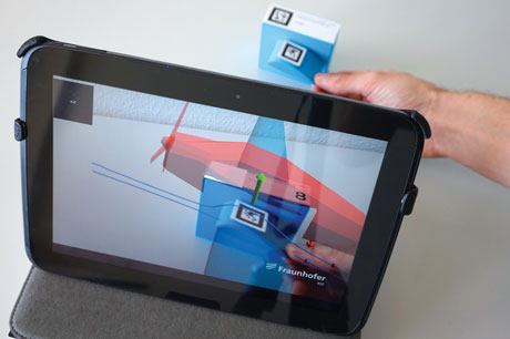 Figure 1: Visualizing forces and airstreams around a miniaturized wing using Augmented Reality.