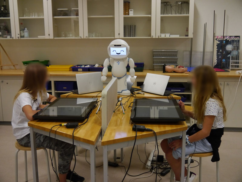 Figure 1: QTrobot welcomes children to the activity.
