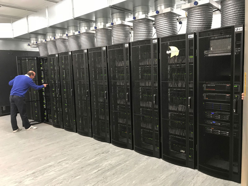Figure 1: The million-core SpiNNaker machine at Manchester. The machine occupies 10 rack cabinets, each with 120 SpiNNaker boards, power supplies, cooling and network switches. The 11th cabinet on the right contains servers that support configuration software and remote access to the machine.