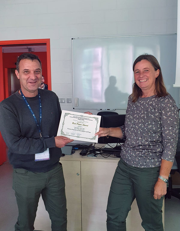 Franck Cassez receives the FMICS 2022 Best Paper Award from Marieke Huisman (picture by Paula Herber) 