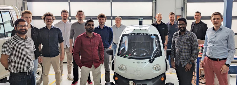 The project team with the test vehicle. Within the project, the developed approach is evaluated on two use-cases. One of these use-cases involves pedestrian tracking on a vehicle. 