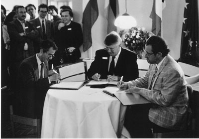 The 'birth' of ERCIM: From left - Alain Bensoussan, INRIA, Friedrich Winkelhage, GMD (on behalf of Gerhard Seegmüller) and Cor Baayen, CWI, sign the joint agreement on 13 April 1989. The birth of ERCIM: From left - Alain Bensoussan, INRIA, Friedrich Winkelhage, GMD (on behalf of Gerhard Seegmüller) and Cor Baayen, CWI, sign the joint agreement on 13 April 1989.