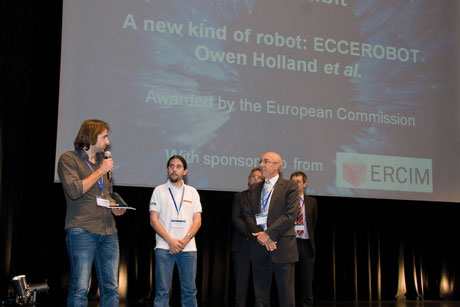 ERCIM President Michel Cosnard awarding a prize winner.
